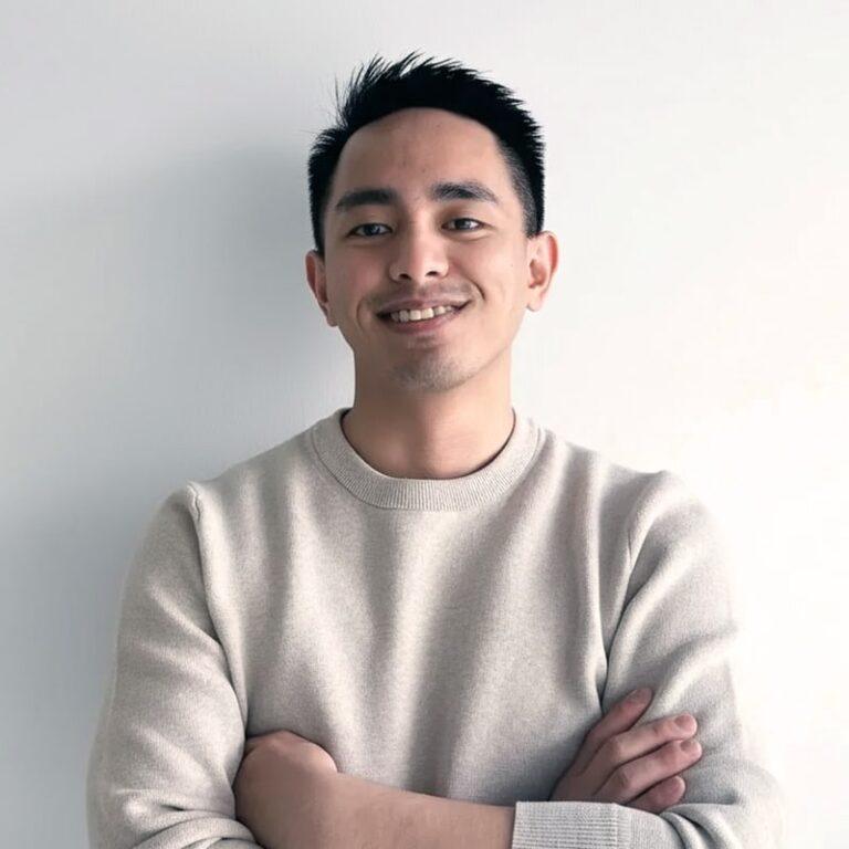 Jasper Lalwet, Manager at Superannuation Warehouse, smiling with arms crossed, wearing a light sweater against a neutral background.